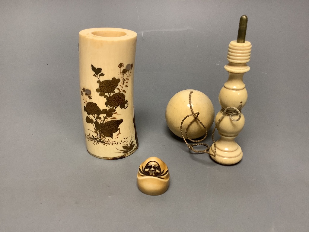 A Japanese gilt lacquered ivory vase, 11.2cm high, a 19th century ivory cup and ball game and an ivory netsuke of Daruma